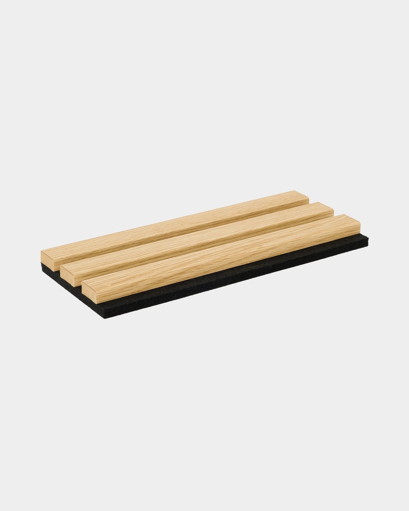 WoodUpp Akupanel sample in Southern Oak, featuring three light wood slats on a black acoustic base with minimalist Nordic design.
